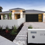 Side-Glass / 2/Car garage doors beautiful home as seen from the driveway