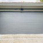 Solid (No glass) / 2-car garage doors Clopay Modern Steel Premium Series w/ Intellicore Model 9209 Charcoal Modern Grooved Design