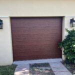 Solid (no glass) / 1-car garage doors Clopay Modern Steel Premium Series Model 4302 / 9208 Ultra-Grain Cypress Walnut Modern Flush Design