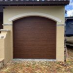 Solid (no glass) / 1-car garage doors Clopay Modern Steel Premium Series Model 4302 Ultra-Grain Cypress Walnut Modern Flush Design