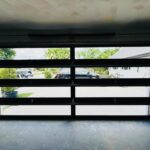 Full-view - (all glass) 2-car garage doors Full-view - Black Frame - Grey glass w/ No Privacy - Interior view