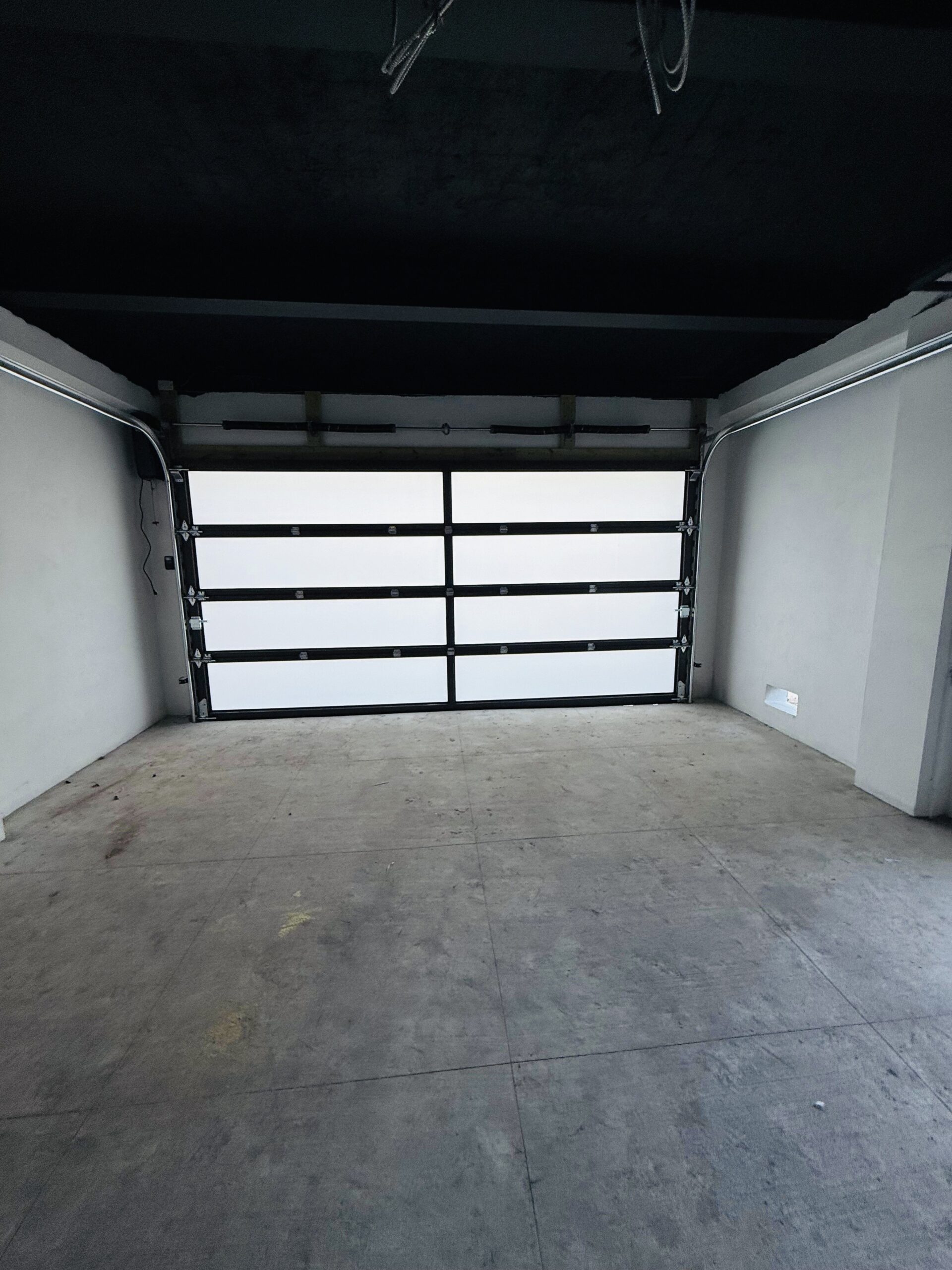 Full-view - (all glass) 2-car garage doors Full-view - Black Frame - Grey glass w/ Privacy - Interior view